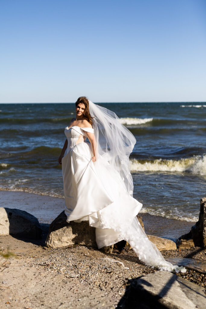 relaxed Toronto wedding bride by lake Ontario during natural portraits